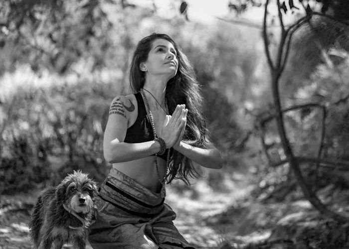 Close-up of a woman's serene face with eyes closed, practicing mindful breathing.