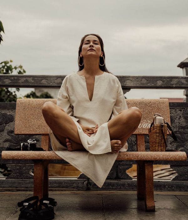 Woman in a calm, seated yoga pose, embodying inner harmony and balance.
